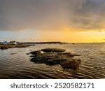 12th Sept 2024 18:54 View across Christchurch Harbour, Dorset, at sunset, looking towards Hengistbury Head and Mudeford Quay.