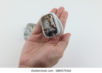 13 amp domestic electric plug with back taken off in hand. Selective focus.