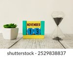 13 November on wooden grey cubes. Calendar cube date 13 November. Concept of date. Copy space for text or event. Educational cubes. Wood blocks in box with date, day and month. Selective focus