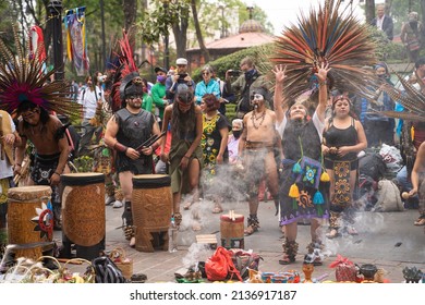 13.02.2022 - Mexico, Coyoacan. Conchero. Mexican Indians In Traditional Clothes Costumes Dance Aztec And Perform On Street. Musicians Playing Drums Near Altar With Smoke. Old Woman Raised Hands