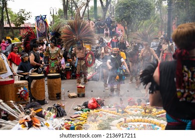 13.02.2022 - Mexico, Coyoacan. Conchero. Mexican Indians In Traditional Clothes Costumes Dance Aztec And Perform On Street. Musicians Playing Drums Near Altar With Smoke. Old Woman Performing 