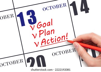 13th day of October. Hand writing text GOAL PLAN ACTION on calendar date October 13. Motivation for a new day. Business concept. Autumn month, day of the year concept.