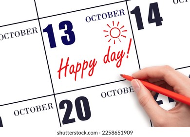 13th day of October. Hand writing the text HAPPY DAY and drawing the sun on the calendar date October 13. Save the date. Holiday. Motivation. Autumn month, day of the year concept.