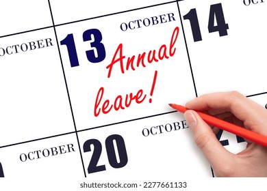 13th day of October. Hand writing the text ANNUAL LEAVE and drawing the sun on the calendar date October 13. Save the date. Time for the holidays. vacation calendar. Autumn month, day of the year.