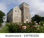 13th-century castle in Turku, Finland; roses in the foreground 