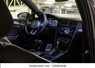 
14 December 2019 Riga, Latvia Volkswagen VW Mk7 Golf GTI TCR (road car) Touring Car Racing standing on parking slot, Garage background, open door, dashboard view with wheel, navigation system.