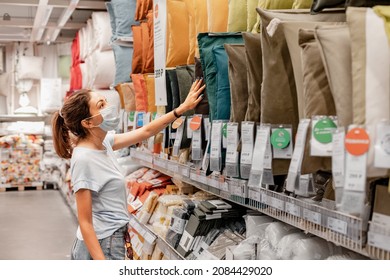 14 June 2021, Ufa, Russia: The Woman In Face Mask Shopping For Pillow And Cushions In An IKEA Store