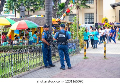 14 Nov 2018 - Cebu, The Philippines: Two Policemen Protect The Local Festival. Ethnic People Policemen. Filipino Festival Safety. Big City Outdoor Event. Harvest Festival In Park. Philippine Fiesta