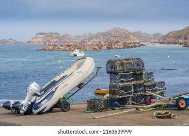 14.05.2022 Isle of Iona, Inner Hebrides, Scotland, Uk. A white speed boat and engine on a trailer next to lobster nets on the isle of mull