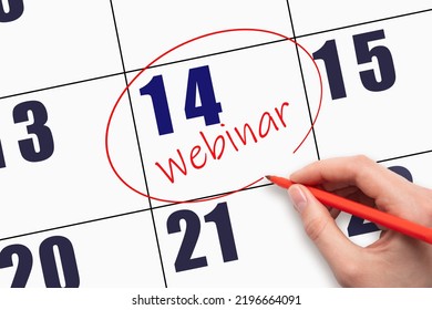 14th day of the month. Hand writing text WEBINAR and circling the calendar date. Webinar date on calendar or agenda. Day of the year concept. - Powered by Shutterstock