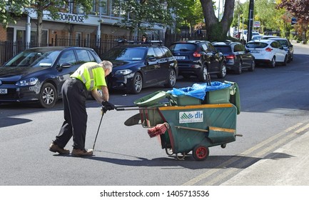 
14th May 2019, Dublin, Ireland. Man In Hi Vis Picking Up Litter On The Streets Of Dun Laoghaire With A Litter Picker Stick, On Behalf Of The County Council.