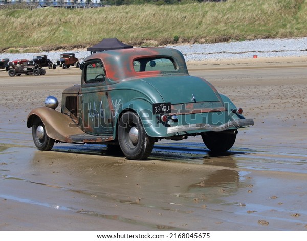 14th\
May 2022- An old Ford Model 40, two door coupe, being driven on the\
sandy beach at Pendine, Carmarthenshire, Wales,\
UK.