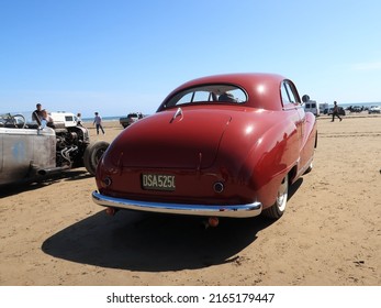 14th May 2022- A red customised 1953 Austin A40 Somerse, two door saloon car, parked on the sandy beach at Pendine, Carmarthenshire, Wales, UK.