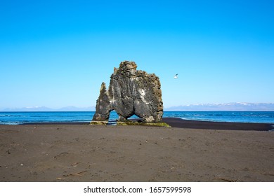 Hvítserkur is a 15 m high basalt stack along the eastern shore of the Vatnsnes peninsula, in northwest Iceland. The rock has two holes at the base.