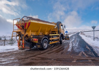 15.12.2019 Ribblehead, North Yorkshire, UK, A Yellow Gritter Lorry Out On The Rd Between Ribblehead And Hawes Clearing Snow And Ice From From The Road Surface.