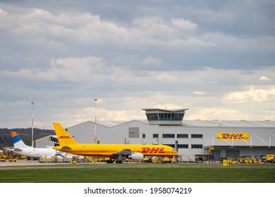 15.4.2021 DHL Cargo hub East Midlands Airport Nottingham.
Yellow Boeing 737 aircraft delivering packages freight cargo central UK distribution hub EMA Nottinghamshire. Control tower planes on runway.