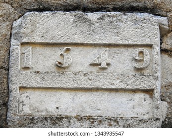 1549 AD Isolated Inscription Carved On Stone. 16th Century Inscription On Old Building Wall Listing An Exact Year Number During The Kingdom Of France In The Renaissance And Early Modern Period