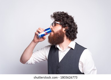 15/august/2020, Moldova/Chisinau- Young Bearded Man In Casual Drinking Red Bull