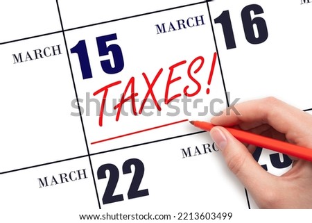 15th day of March. Hand drawing red line and writing the text Taxes on calendar date March 15. Remind date of tax payment. Tax day concept. Spring month, day of the year concept. Stock photo © 