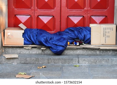 15th November 2019, Dublin, Ireland. Two homeless people sleeping outside the red door of St. Ann’s Church, Dawson Street, with their heads inside cardboard boxes to protect them from the elements. 