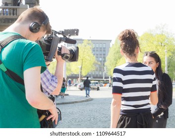 16 April 2018 - Mannheim, Germany: TV News Reporter And Camera Crew Are Taking An Interview And Shooting Local Woman In Front Of The Water Tower In Mannheim.