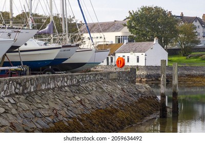 16 October 2021. Boats in the winter storge yard beside the slipway in Groomsport harbour in County Down Northern Ireland. The anient Irish Cottages on Cockle Row can be seen in the background 