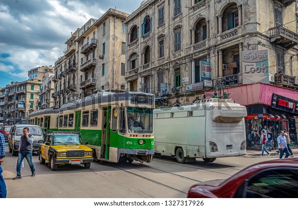 16/11/2018\
Alexandria, Egypt, the streets of an ancient African city filled\
with people and trams and old Soviet\
cars
