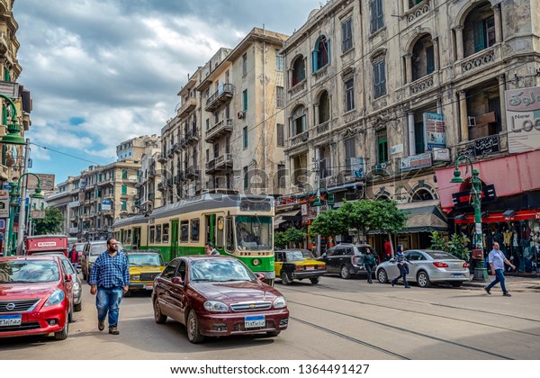 16/11/2018\
Alexandria, Egypt, the streets of an ancient African city filled\
with people and trams and old Soviet\
cars