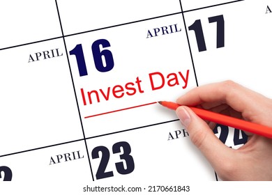 16th day of April.  Hand drawing red line and writing the text Invest Day on calendar date April 16.  Business and financial concept. Spring month, day of the year concept.