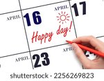 16th day of April. Hand writing the text HAPPY DAY and drawing the sun on the calendar date April 16. Save the date. Holiday. Motivation. Spring month, day of the year concept.