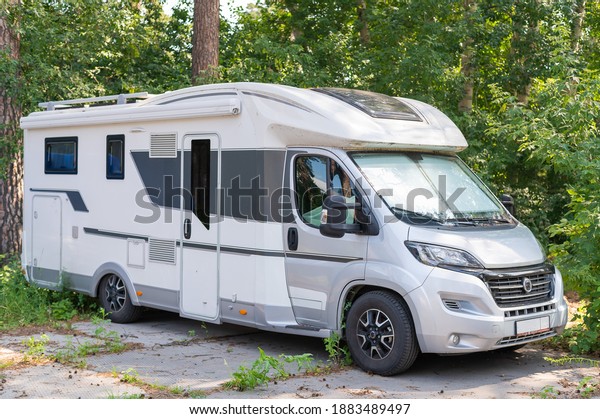 17 july 2020, Russia, Novosibirsk: A white mobile\
home is parked in the woods. Caravan for life and family road\
travel. No people.