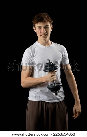 17 year olf teen boy using a dumbbell