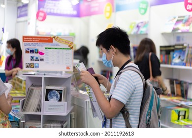 18 07 2021 Boy With Face Mask And School Bag Read Books And Listen To Music In Book Fair In Hong Kong Convention And Exhibition Center , Wan Chai During Covid-19