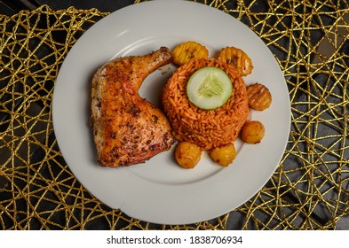 18 October 2020, Ibadan Oyo State  ,NIGERIA
Image Of Jollof Rice With Fried Plantain, Chicken And Cucumber In Ibadan,Nigeria  