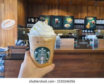 18 Sep 2019: Nonthaburi Thailand; Handed Starbucks Iced Pumpkin Latte Cup At Starbucks Cafe Coffee Shop