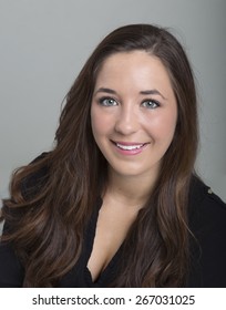 18 Year Old Female Head Shot On A Grey Background