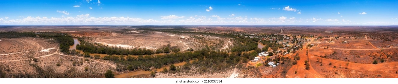 180 degrees aerial panorama of WIlcannia town on Darling river in Australian outback with red soil bushlands.