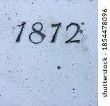 "1812" carved in stone – taken from an inscription produced that year. Covered with some lichen