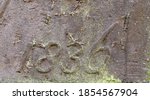 "1836" carved in stone – a detail of an inscription produced that year. Covered with countless small dots of lichen