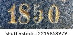 "1850" carved in stone and painted in gold – a detail of an inscription produced that year. Some of the paint is flaking off