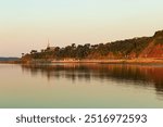 The 1854 Saint-Michel-de-Sillery church dominating a cape and a small cove in the St. Lawrence river seen during a beautiful golden hour late summer sunrise in the Sillery area, Quebec City
