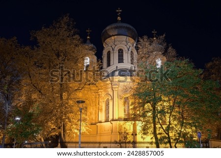 1869 Metropolitan Cathedral of Saint Mary Magdalene Orthodox church facade with Christian crosses on top of the domes illuminated at night in the Praga borough Warsaw, Poland.