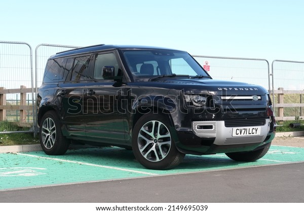 18th April 2022- A black Land Rover Defender\
XS Edition PHEV Auto, five door suv, parked in the public carpark\
at Pendine, Carmarthenshire, Wales,\
UK.