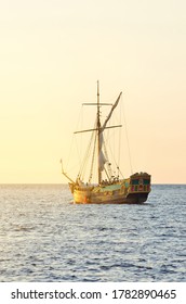 18th Century Sailing Yacht In Open Sea At Sunset, Close-up. Old Tall Ship. Recreation, Cruise, Historical Reenactment Concepts