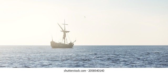 18th century sailing yacht in an open sea at sunset, close-up. Holland. Old tall ship. Recreation, vacations, cruise, historical reenactment, past, history