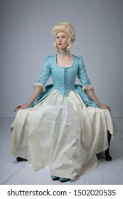 18th Century Woman In Blue Bodice And Cream Skirt