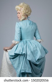 18th Century Woman In Blue Bodice And Cream Skirt