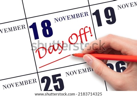 18th day of November. Hand writing text DAY OFF and drawing a line on calendar date 18 November. Vacation planning concept. Autumn month, day of the year concept. Photo stock © 