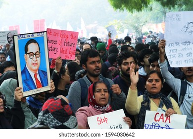 19 December 2019, New Delhi, India. Commom People Protest Againt Citizenship Amendment Bill Holding A Photoframe Of B. R. Ambedkar And Poster. 