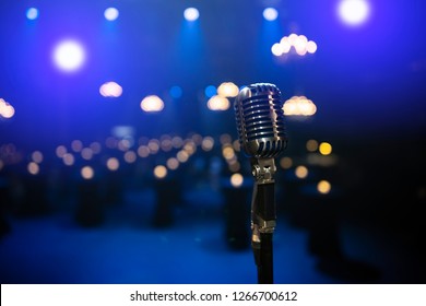 1940s Retro Microphone On The Stage With Lights Shining On The Background